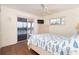 Cozy bedroom with balcony access, featuring warm hardwood floors and a bright, airy atmosphere for comfortable living at 342 S Gulf Blvd, Placida, FL 33946