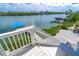 Stairway view to waterfront, dock with boat lift, and lush greenery enhancing the outdoor experience at 342 S Gulf Blvd, Placida, FL 33946