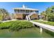 Elevated waterfront home with outdoor stairs leading to screened in porch at 342 S Gulf Blvd, Placida, FL 33946