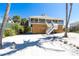 Stunning elevated beach house with white stairs and beautiful landscaping in a sunny, coastal setting at 342 S Gulf Blvd, Placida, FL 33946