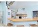 Bright eat-in kitchen with light blue walls, white cabinetry, stainless steel appliances and granite countertops at 342 S Gulf Blvd, Placida, FL 33946