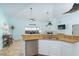 Bright kitchen with stainless steel dishwasher, granite countertops and kitchen bar area at 342 S Gulf Blvd, Placida, FL 33946