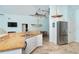 Open concept kitchen area with stainless steel appliances, white cabinets and eat in counter area at 342 S Gulf Blvd, Placida, FL 33946
