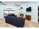 Comfortable living room with a fireplace, large TV, and sliding glass doors to a screened-in lanai at 342 S Gulf Blvd, Placida, FL 33946