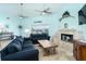 Spacious living room has comfortable sofas, a stone fireplace, and sliding doors to provide scenic outdoor views at 342 S Gulf Blvd, Placida, FL 33946