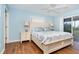 Comfortable bedroom features include two lamps, hardwood floors, and slider door entry to the lanai at 342 S Gulf Blvd, Placida, FL 33946