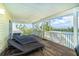Large screened-in porch with comfortable lounge chairs with views of the water to create a perfect relaxation spot at 342 S Gulf Blvd, Placida, FL 33946