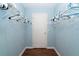 Simple walk-in closet with painted light-blue walls, white trim and wire shelving at 342 S Gulf Blvd, Placida, FL 33946