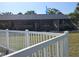 View of backyard with white fence and screened-in patio at 351 Bobby Jones Rd # 351, Sarasota, FL 34232