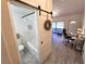 Stylish bathroom featuring a barn door, tub, and shower with white subway tile at 351 Bobby Jones Rd # 351, Sarasota, FL 34232