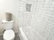 Bathroom features a toilet, tub and shower with white subway tile and a shower curtain at 351 Bobby Jones Rd # 351, Sarasota, FL 34232