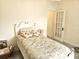 Cozy bedroom featuring a bed with floral bedding, a doorway, and neutral wall paint at 351 Bobby Jones Rd # 351, Sarasota, FL 34232