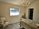 Comfortable bedroom with natural light, a decorative chandelier, and an organized closet at 351 Bobby Jones Rd # 351, Sarasota, FL 34232