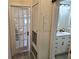Hallway with view of bathroom and bedroom with a glass paneled door at 351 Bobby Jones Rd # 351, Sarasota, FL 34232