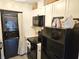 Efficient kitchen with stackable washer/dryer, white cabinetry, and modern appliances at 351 Bobby Jones Rd # 351, Sarasota, FL 34232