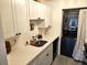 Functional laundry area includes counter space, sink and stacked washer/dryer at 351 Bobby Jones Rd # 351, Sarasota, FL 34232