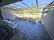 Enclosed patio with view of golf course, potted plants, and outdoor seating at 351 Bobby Jones Rd # 351, Sarasota, FL 34232