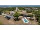 Aerial shot of a community complex featuring convenient parking, a refreshing swimming pool, and mature landscaping at 3586 Cape Haze N Dr # B6, Rotonda West, FL 33947