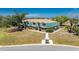 Expansive view of a two-story condo complex featuring unique architecture and beautiful surrounding landscaping at 3586 Cape Haze N Dr # B6, Rotonda West, FL 33947