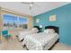 Bright bedroom features two twin beds, a ceiling fan, and a window with natural light at 3586 Cape Haze N Dr # B6, Rotonda West, FL 33947