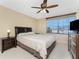 Comfortable bedroom with a king bed, side table, and a large window with blinds at 3586 Cape Haze N Dr # B6, Rotonda West, FL 33947