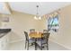 Cozy dining area featuring a round table with seating for four and a window with a view of the outdoors at 3586 Cape Haze N Dr # B6, Rotonda West, FL 33947
