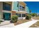 Charming condo featuring a bright green door, well-manicured bushes and a freshly poured sidewalk on a sunny day at 3586 Cape Haze N Dr # B6, Rotonda West, FL 33947