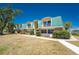 Charming condos with a turquoise roof, lush landscaping, and well-maintained lawn at 3586 Cape Haze N Dr # B6, Rotonda West, FL 33947