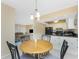 Bright eat-in kitchen with a round table, black appliances, and a view into the living room at 3586 Cape Haze N Dr # B6, Rotonda West, FL 33947