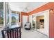 Bright sunroom with a view of the living room, featuring tile floors and comfortable seating at 3586 Cape Haze N Dr # B6, Rotonda West, FL 33947