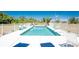 Community pool with lounge chairs, lush landscaping and plenty of space to relax at 3586 Cape Haze N Dr # B6, Rotonda West, FL 33947
