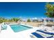 Refreshing community pool surrounded by lounge chairs and tropical landscaping at 3586 Cape Haze N Dr # B6, Rotonda West, FL 33947