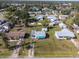 Aerial view of a single-story home surrounded by lush greenery and marked property lines in a quiet neighborhood at 360 W Cowles St, Englewood, FL 34223