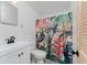 Full bathroom featuring a tiled shower with decorative shower curtain and simple white vanity at 360 W Cowles St, Englewood, FL 34223