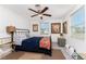Cozy bedroom with neutral walls, a ceiling fan, and two windows for lots of natural light at 360 W Cowles St, Englewood, FL 34223