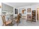 Open-concept dining area with beachy decor, wood-look flooring, and easy access to the kitchen at 360 W Cowles St, Englewood, FL 34223