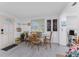 Bright dining area with wood-look floors, coastal decor, and a glass-top table at 360 W Cowles St, Englewood, FL 34223