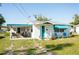 Charming single-story home with a well-maintained lawn and a inviting covered porch at 360 W Cowles St, Englewood, FL 34223