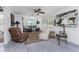 Inviting living room with neutral walls, wood-look floors, a ceiling fan, and lots of natural light at 360 W Cowles St, Englewood, FL 34223