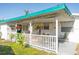 Covered porch with chairs and hanging plants providing an outdoor living space at 360 W Cowles St, Englewood, FL 34223