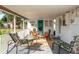 Spacious covered porch with comfortable seating, perfect for relaxation and outdoor enjoyment at 360 W Cowles St, Englewood, FL 34223