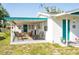 Relaxing covered porch with dining and seating area perfect for outdoor enjoyment at 360 W Cowles St, Englewood, FL 34223
