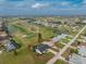 Real estate aerial view of a single-Gathering home with a pool, near a golf course and waterways at 4 Bunker Rd, Rotonda West, FL 33947