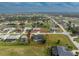 The aerial shot captures the house, complete with a screened lanai and pool, set in a picturesque neighborhood at 4 Bunker Rd, Rotonda West, FL 33947