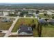 Real estate aerial view of a single-Gathering home with a pool, located in a quiet neighborhood at 4 Bunker Rd, Rotonda West, FL 33947
