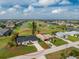 Aerial view of a single-Gathering home next to a golf course at 4 Bunker Rd, Rotonda West, FL 33947