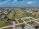 An aerial view of a neighborhood with houses near a golf course and waterways at 4 Bunker Rd, Rotonda West, FL 33947