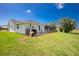 Backyard view of home including screened pool and patio at 4 Bunker Rd, Rotonda West, FL 33947