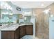 Bathroom showcasing a dual-sink vanity, tile shower, and modern fixtures at 4 Bunker Rd, Rotonda West, FL 33947