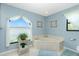 Bathroom featuring a corner tub, decorative window, and neutral color palette at 4 Bunker Rd, Rotonda West, FL 33947